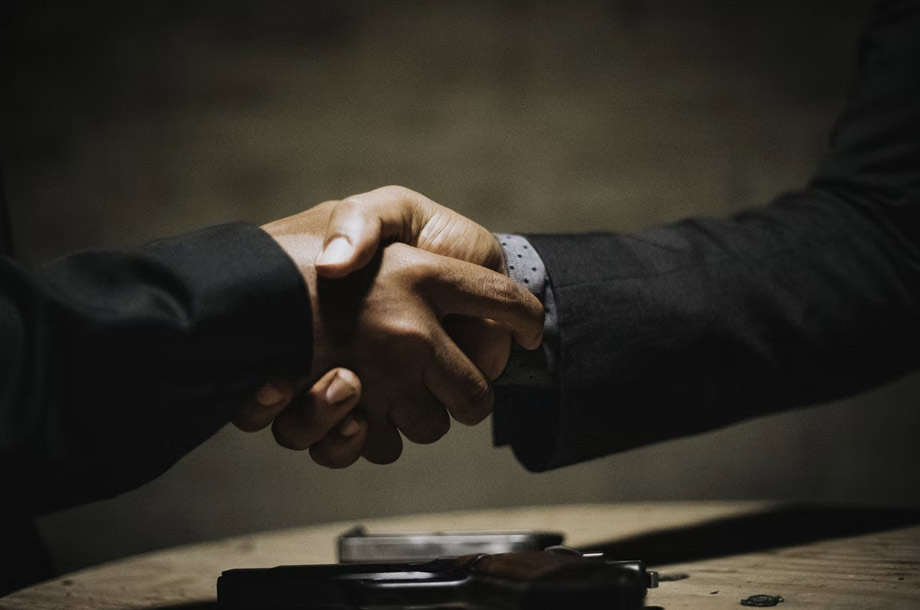 Close up of business men shaking hands