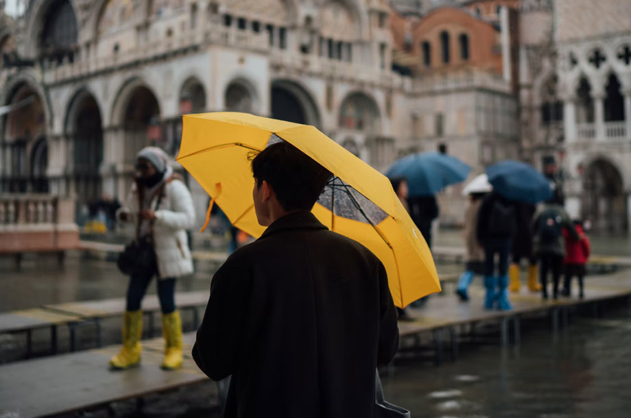 Man walking with yellow umbrella